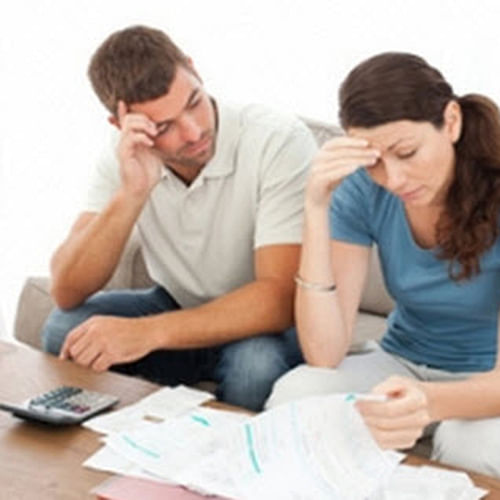 Image of a couple paying bills.