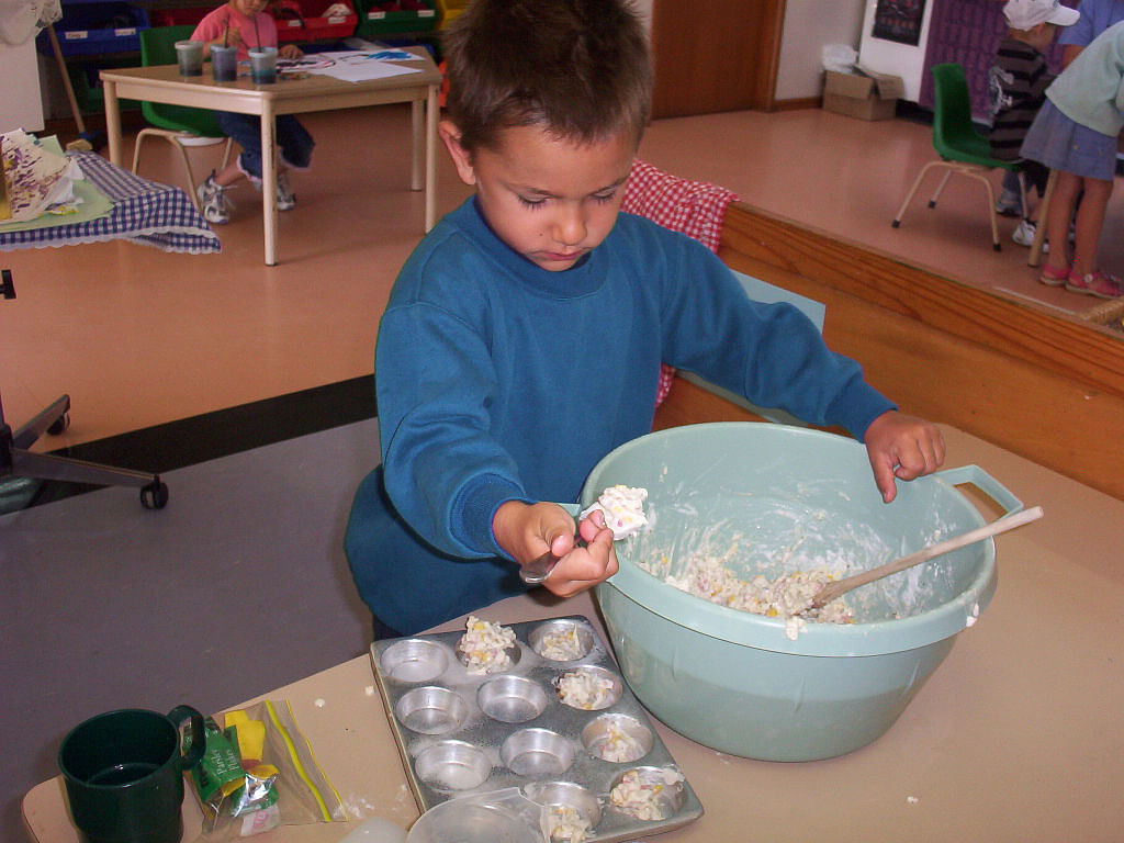 Image of a child cooking.