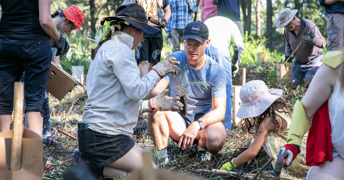 A group of people planting tree saplings in Bega NSW