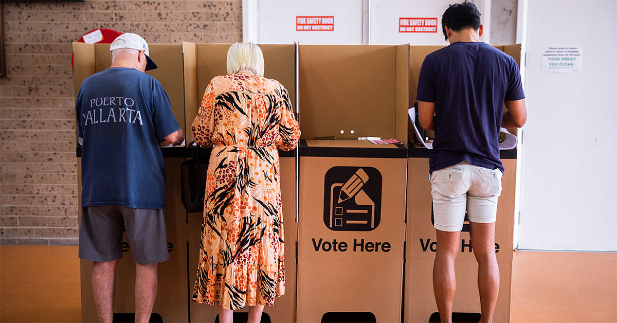 Image of three people voting.