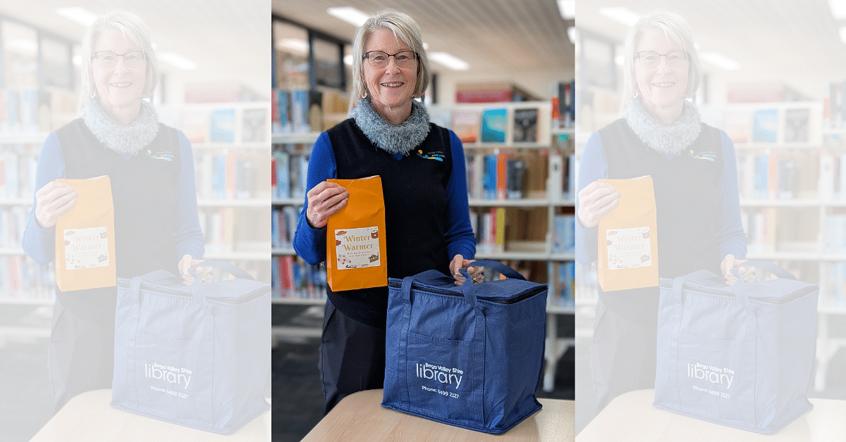 Acting Library Services Coordinator, Linda Albertson with a Winter Warmer goody bag and Library Link delivery bag.