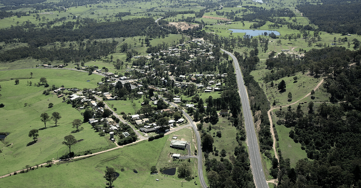 An aerial view of Wolumla village with surrounding fields and forest
