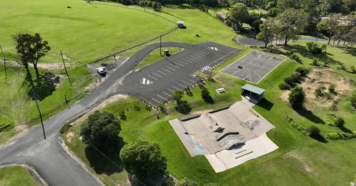 aerial shot of a carpark, skatepark and basketball court.