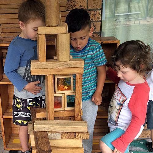 children playing with wooden blocks