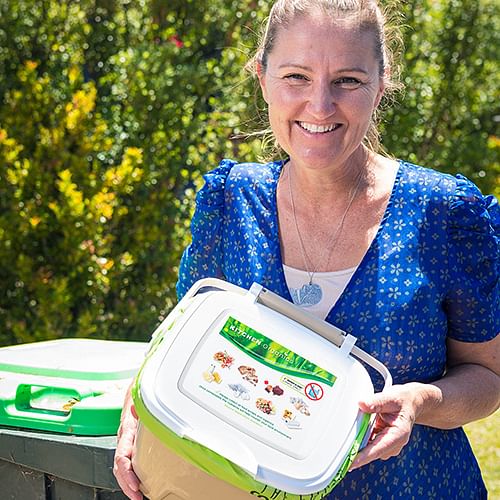 Bega Valley Waste Management Coordinator Joley Vidau with new kitchen caddies that the council will deliver to residents when it introduces FOGO.