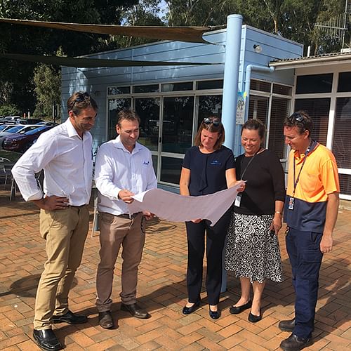 Photograph: Daniel McAlister and Brad Piltz (Joss Construction), Mel Thane (Merimbula Airport Operations), Jennifer Symons (Council's Project Manager) and Chris Thane (Merimbula Airport Operations) go over the plans for the Merimbula Airport Terminal Extension.