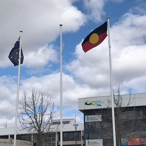 Aboriginal and Australian flags fly side by side in Littleton Gardens, Bega.