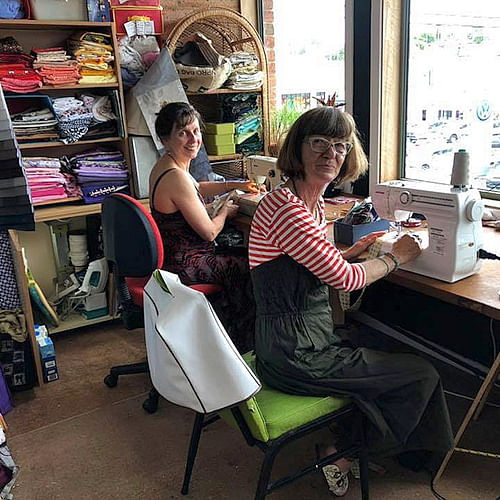 People learning to sew at the Bega Funhouse with Boomerang Bags.