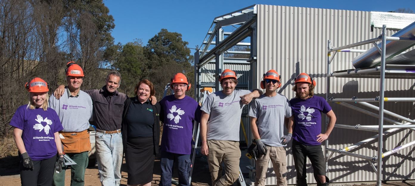 Dean, pictured with Council's Kelly McDowall and All Hands and Hearts volunteers, has received a bathroom unit through the Water and Sanitation project.