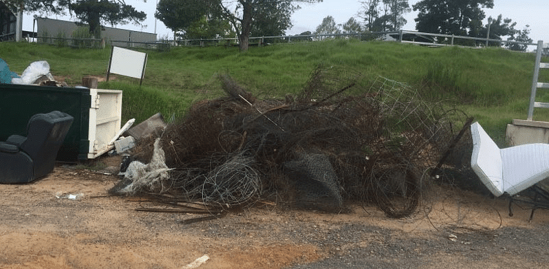 Illegally dumped furniture and fencing at the Cobargo showground general waste skips.