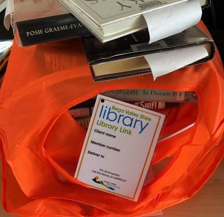 Library books in a REDcycle plastic bag.