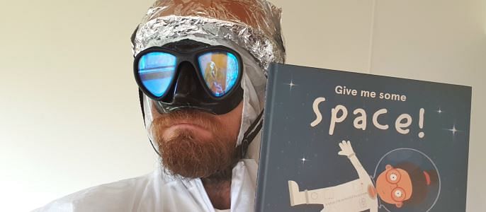 Paul West is all systems go to read Give Me Some Space for National Simultaneous Storytime.