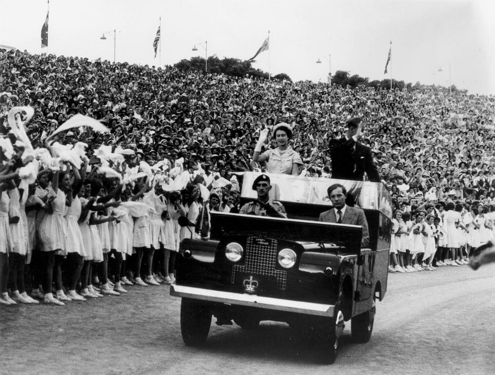 Crowds of schoolchildren greet The Queen and Prince Philip at Brisbane's Exhibition Grounds, 1954
