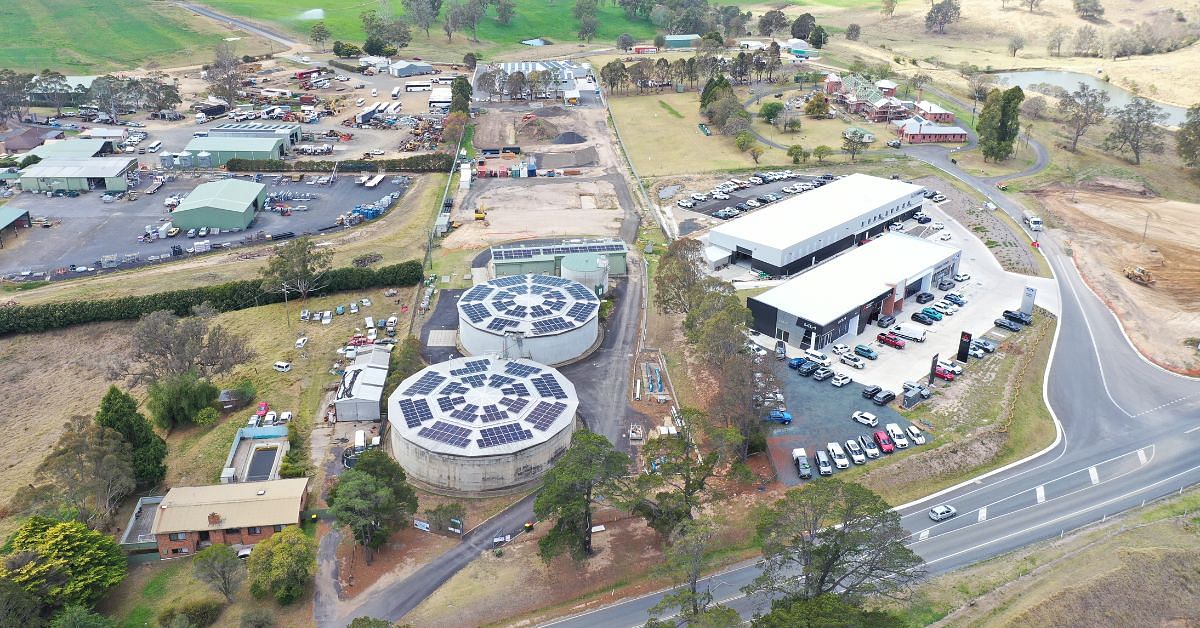 An aerial shot of solar panels on the roof of water tanks and a building in Bega