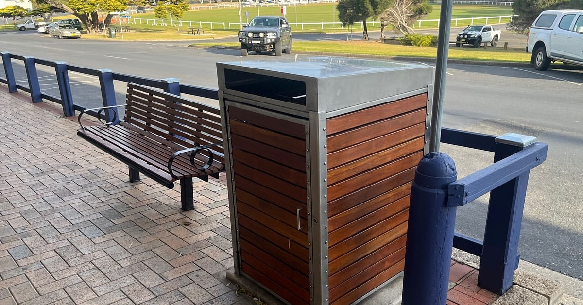 main street bermagui with new bench seating and bin bank with railing painted blue