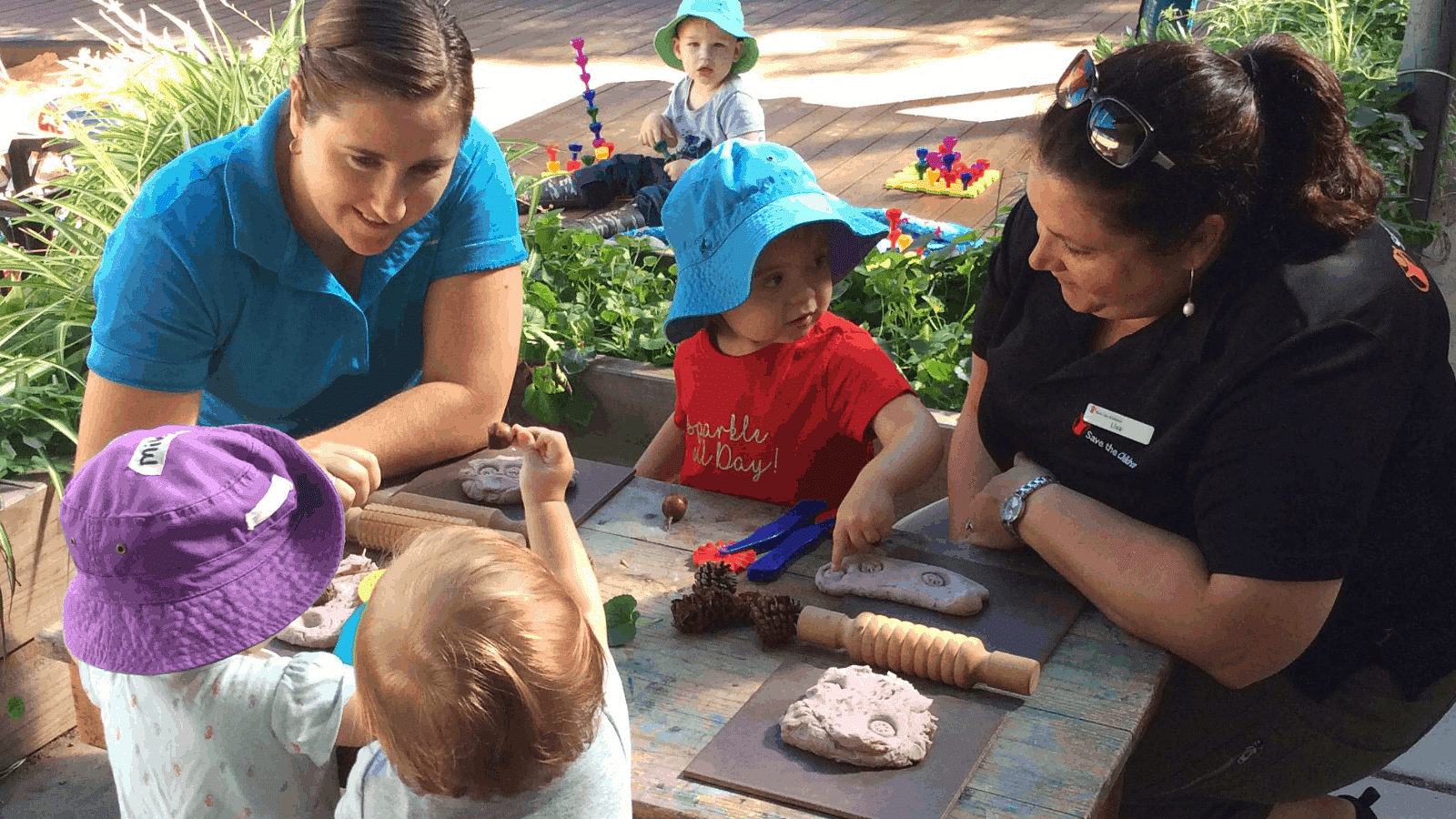 Bandara child care centre staff and children play at crafts.