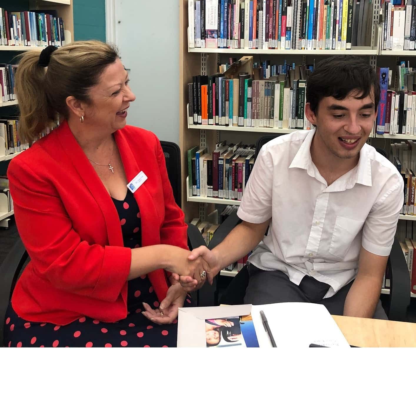 Sapphire Coast Anglican College Principal, Tracey Gray congratulates student Ben Cook for his achievements at Bega Library.