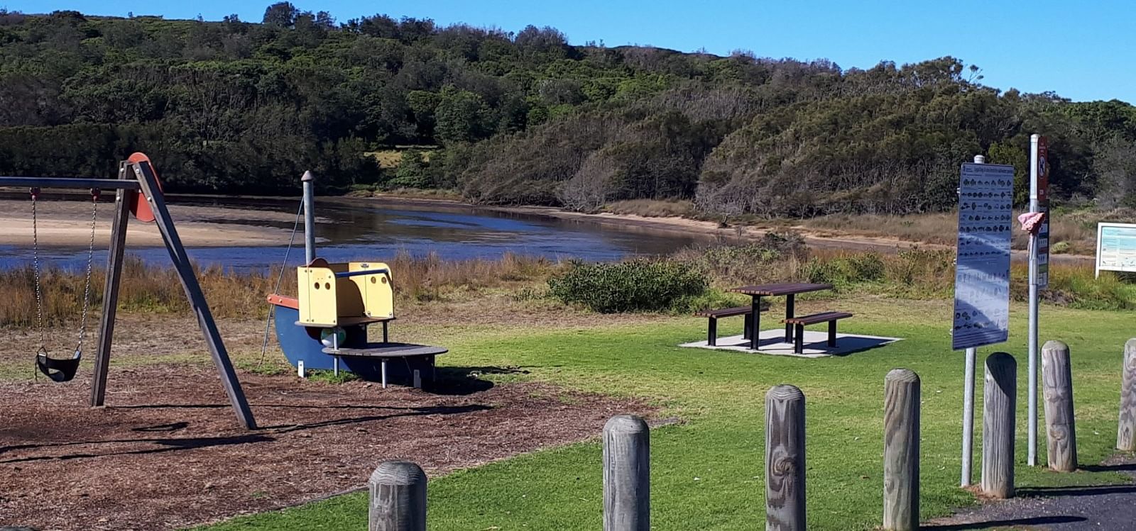 A playground on the edge of a lake 