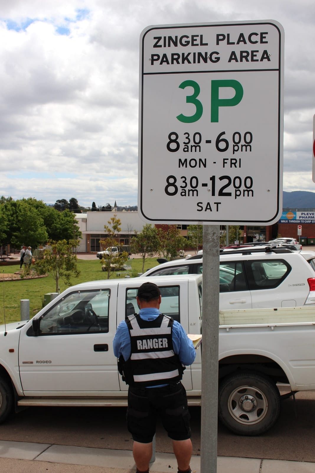 Parking ranger booking a car.