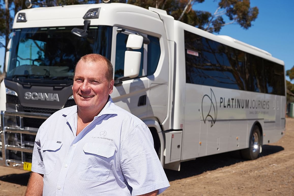 Paul Pincini standing in front of one of his new all-terrain touring buses.