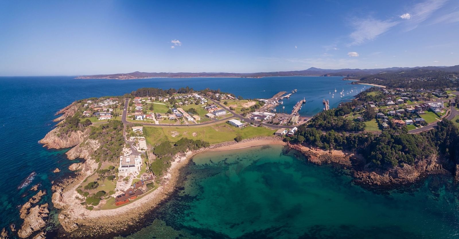 An aerial view of a headland and port area in Eden