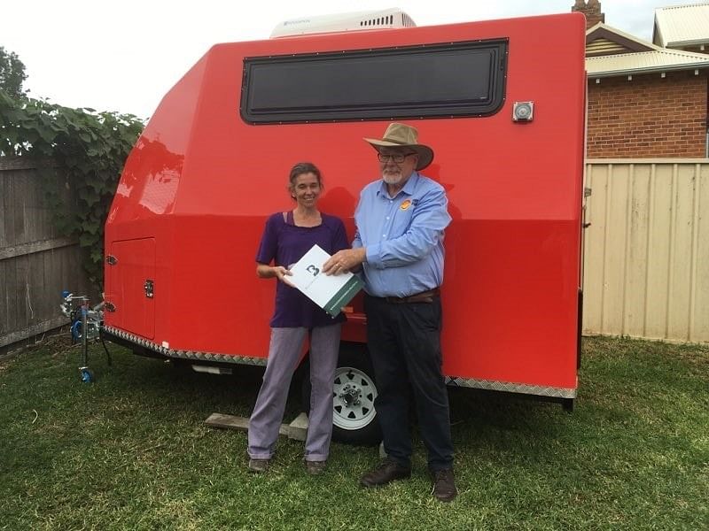 Sharleen Salter, owner of The Country K9 Parlour with Cobargo RFS president John Walters in front of her donated dog grooming van.