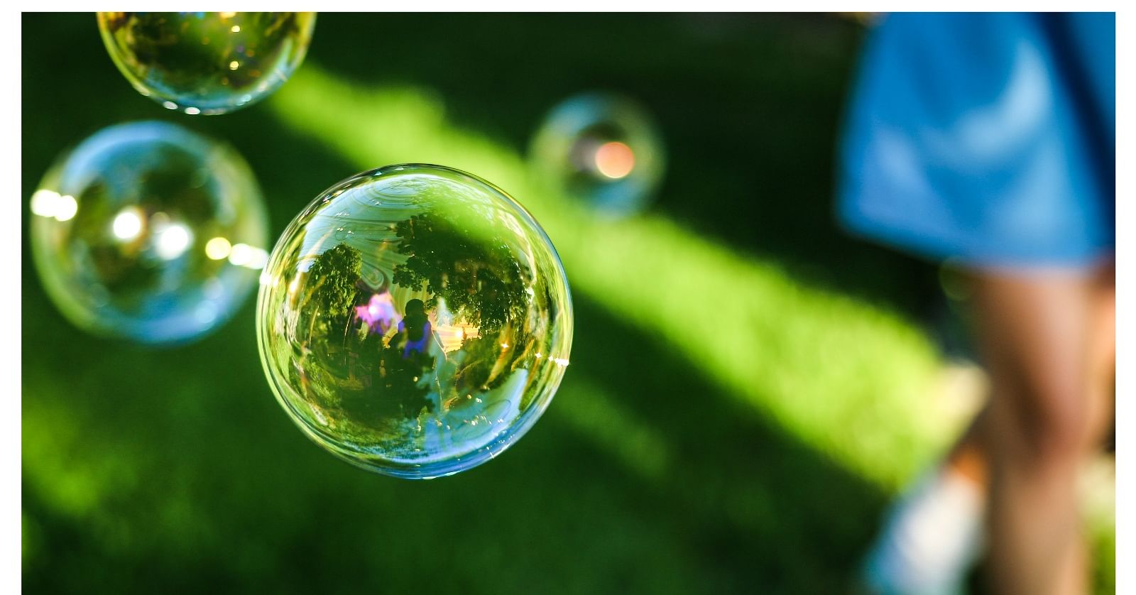 Bubbles floating as a girl walks by