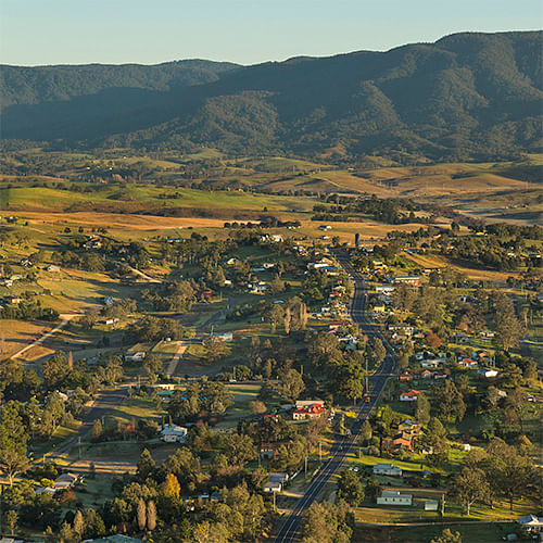 Text: ariel view of bemboka town and mountains