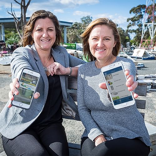 Mayor, Cl Kristy McBain and Waste Management Co-ordinatory Joly Vidau showing the waste app on their phones.