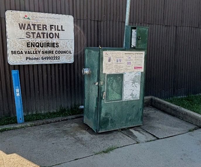 Current green water fill station. Big green box with complicated instruction board.